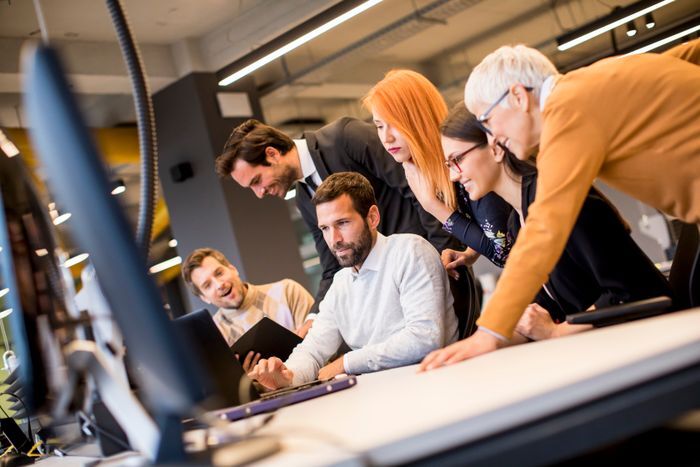 Senior businesswoman working together with young business workers