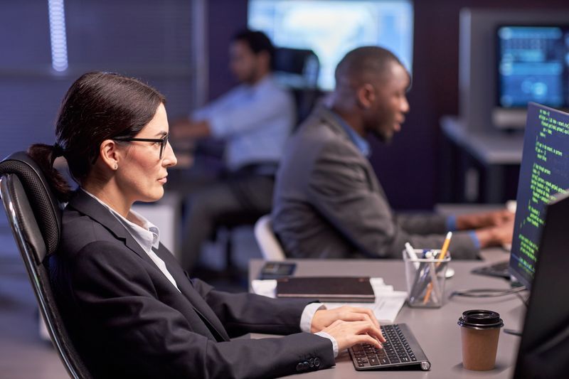 Serious businesswoman using computer at workplace